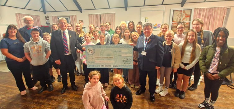 The Sleeping Beauty chorus donating £908.40 to Kevin Scannell and Carole Lawrie from the Royal British Legion Abergavenny Branch.
