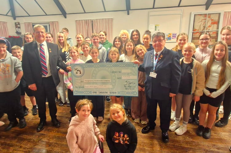 The Sleeping Beauty chorus donating £908.40 to Kevin Scannell and Carole Lawrie from the Royal British Legion Abergavenny Branch.