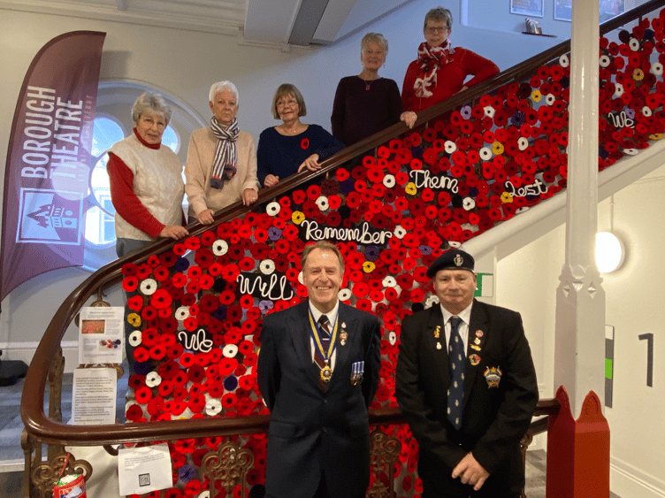 Members of the Abergavenny Yarnies Group are joined by reps of the town's RBL branch to unveil their remembrance display