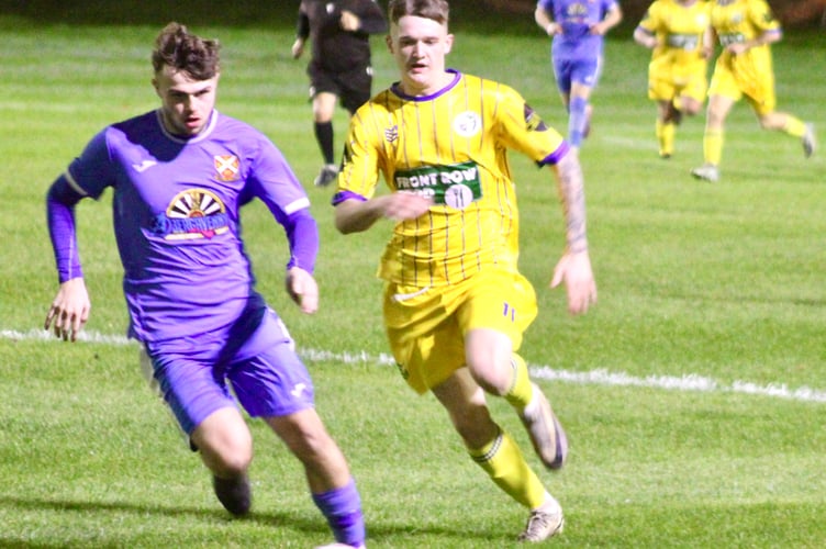 An Aber player drives forward in Friday night's Pen-Y-Pound derby
