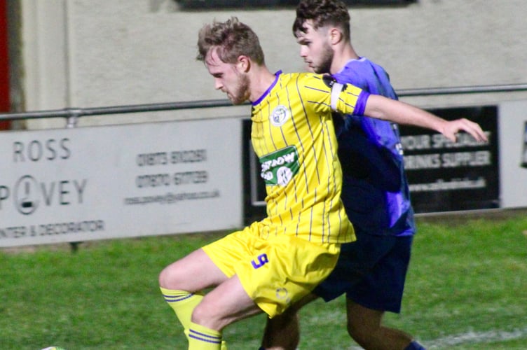 A Blaenavon player shields the ball from a Pennies attacker