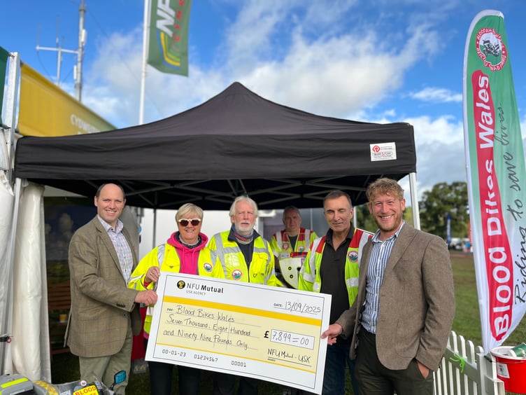 NFU Mutual Usk Agency agents, Jeremy Tancock and Richard Phillips, presenting the donation at Usk Show to volunteers working for Blood Bikes Wales