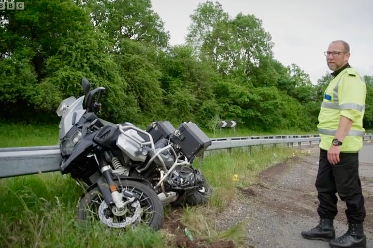 PC Richie Wyatt examines the damaged bike in BBC One's The Crash Detectives