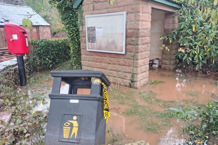 The flood level marked in the wall of the bus shelter