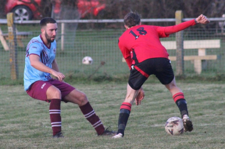 A Mardy player looks to beat a Cwmbran defender