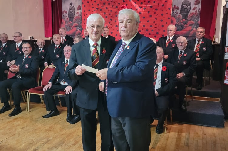 Tredegar Orpheus Male Voice Choir Chairman Trevor White (left) presents Charity Trustee Neil Gregory (right) with a cheque for £600, proceeds from ticket sales for the evening.