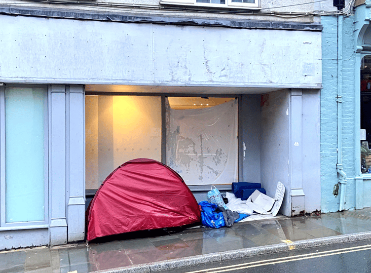 The tent and belongings occupying the frontage of the former Halifax Bank