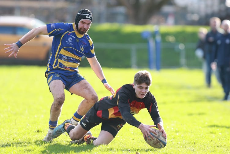 A Brynmawr player beats a Monmouth forward to the ball