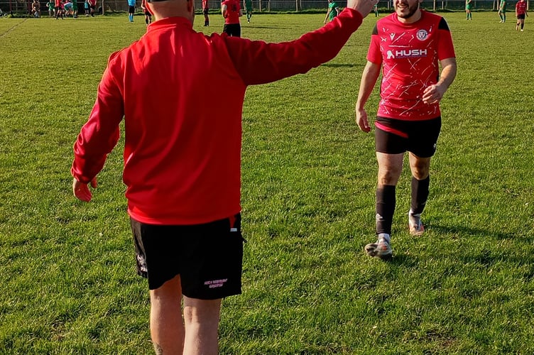 Leighton Melia is congratulated by Mardy manager Dai Sadler after a goal, two assists and a shot that hit the post.