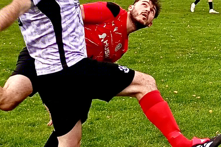 Leighton Melia tussels with a New Inn player