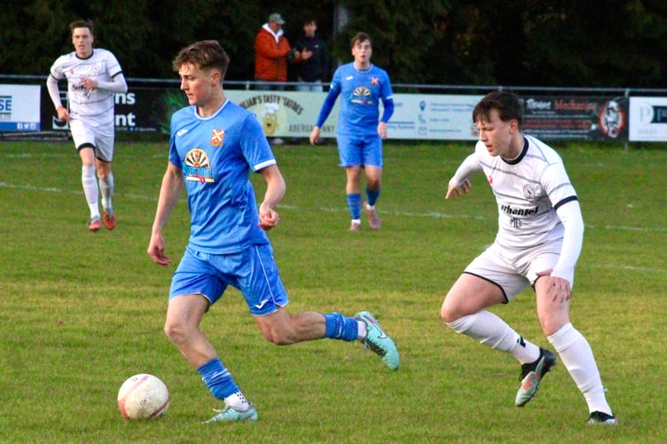 An Aber player shields the ball from a Crows' opponent