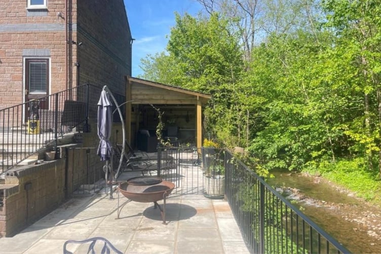 Patio on banks of river gavenny