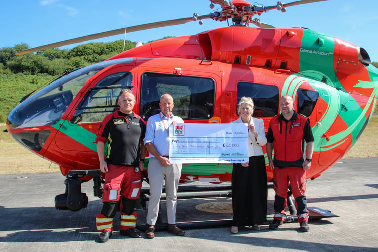 FUW President Ian Rickman hands over the cheque to Dr Sue Barnes, Wales Air Ambulance Charity Chief Executive and two members of the Wales Air Ambulance crew