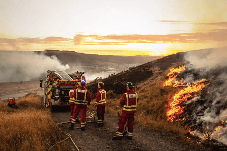 Fire crews battle flames during one of a series of wildfires which have swept across South Wales during a week of exceptionally dry conditions.