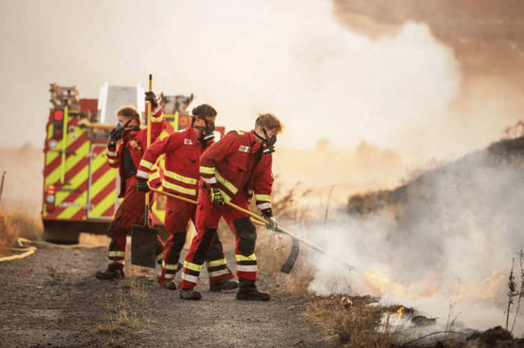 Fire crews battle flames during one of a series of wildfires which have swept across South Wales during a week of exceptionally dry conditions.