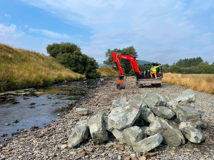Boulders stacked and ready to be placed into the channel