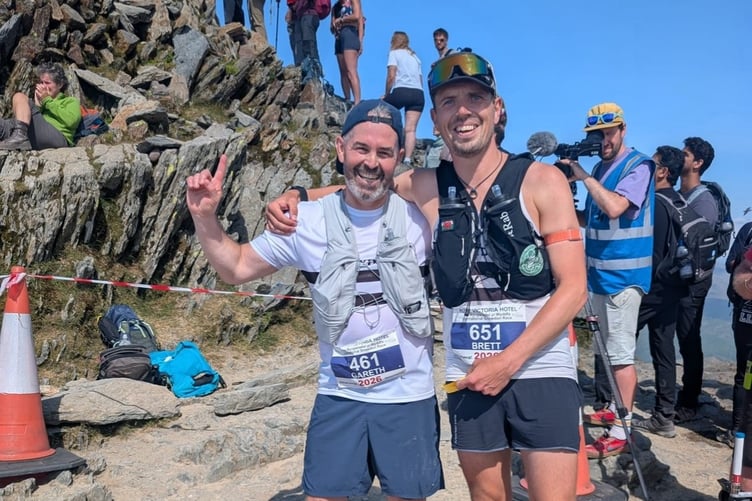 Gareth Davies, left, with his guide, Brett Mahoney, at the summit of Yr Wyddfa