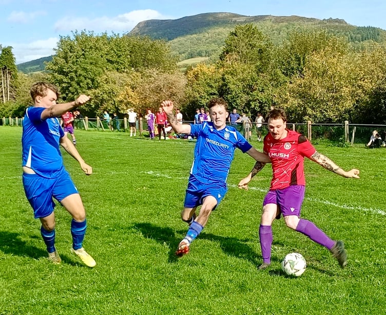 Jake Heckles beats two defenders to cross for Mardy's first goal.